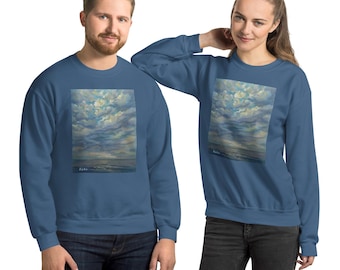May include: Two people wearing matching blue sweatshirts. Each sweatshirt features a rectangular painting of a cloudy sky with shades of blue, white, and yellow. The painting is centered on the front of the sweatshirt.