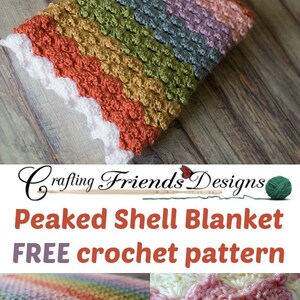 May include: A multi-colored crochet blanket with a peaked shell stitch pattern. The blanket is made with a variety of colors, including pink, purple, blue, green, yellow, and orange. The blanket is shown on a wooden surface. The text "Crafting Friends Designs" and "Peaked Shell Blanket FREE crochet pattern" is displayed on the image.