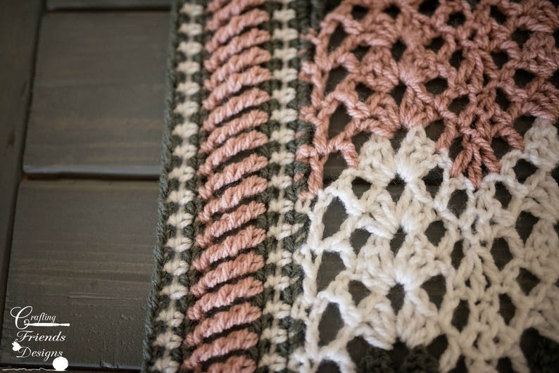 May include: Close-up of a crocheted blanket with a pink, white, and green color scheme. The blanket is made with a variety of stitches and patterns.