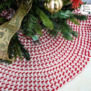 May include: Red and white crocheted Christmas tree skirt with a scalloped edge. The skirt is made with a repeating pattern of diagonal stripes.