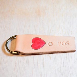 Leather blood-type keychain with red heart inlay. O positive blood type.