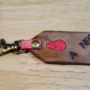 Rustic leather Blood-type keychain. Leather blood-type in bold black, blood drop inlay, and stamped with the American flag on the reverse.