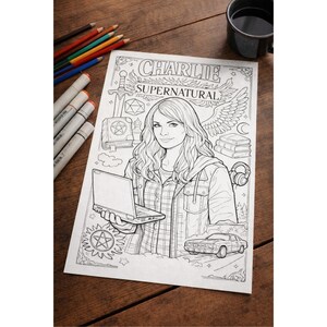 May include: Black and white colouring page with the text "CHARLIE SUPERNATURAL" above an illustration of a woman holding a laptop. The page includes images of a sword, pentagram, books, headphones, a car, and wings.