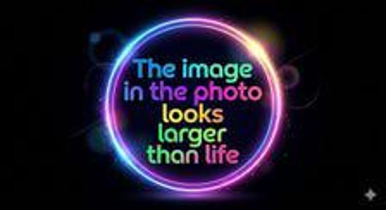 May include: A circular neon light frame in shades of blue, purple, and pink against a black background. Inside the circle, the text reads: The image in the photo looks larger than life. The text is displayed in multiple colors including blue, pink, and green.