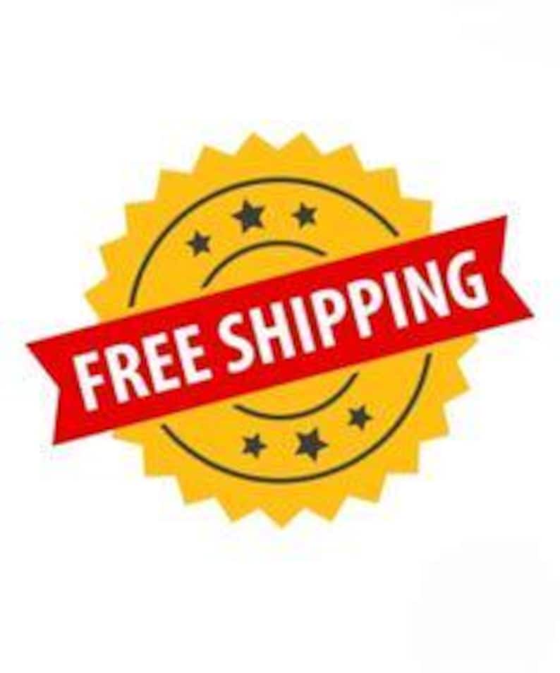 May include: A yellow circular badge with a serrated edge and five black stars arranged in a circle. A red banner is placed diagonally across the center of the badge with the white text FREE SHIPPING printed in a bold, sans-serif font.