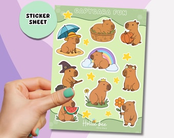 May include: A sticker sheet featuring various cartoon capybaras in different poses and outfits. The sheet includes capybaras with an umbrella, in a basket, with a pumpkin, and more. The text "CAPYBARA FUN" and "STICKER SHEET" are visible.
