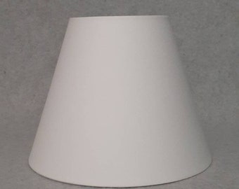 Bright white lamp shade.  Solid.  Shade is 9.5" wide at  the bottom, 5" wide at the top and 7" tall