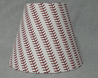 Baseball lamp shade.  Seams.  Red.  Shades are 9.5" wide at the bottom, 5" wide at the top and 7" tall.