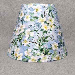 White flowers and branches lamp shade.  Lite blue background.  Dogwood.  Colorful.  Plants.  Flowers. Shades are 9.5&quot; x 5&quot; x 7&quot; tall