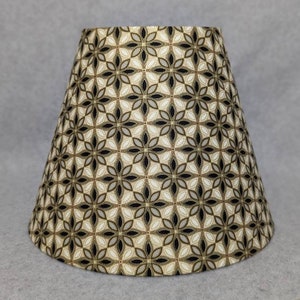Black, gold, grey abstract lamp shade.  Metallic.  Flowers. Shade is 9.5 wide at the bottom, 5" wide at the top and 7" tall