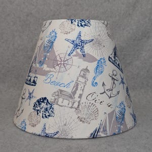 Blue and white nautical Ocean shade. Beach life.   Shells. Sea. Anchors. Rope  Wheel. Shades are 9.5 x 5 x 7 tall.