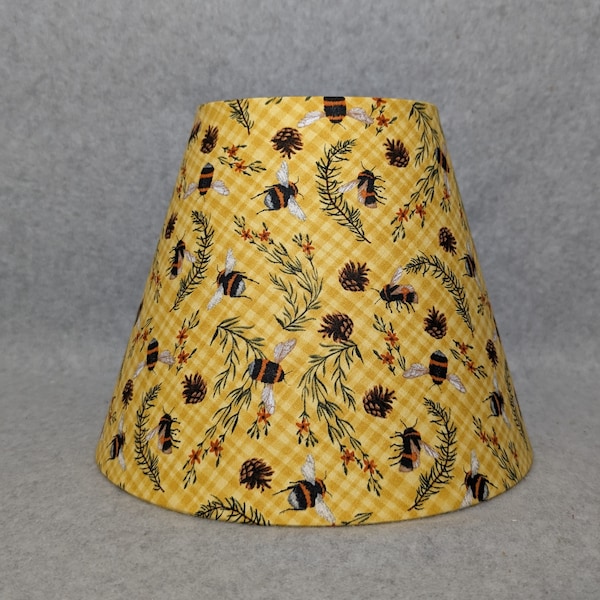 Yellow plaid bees and pinecones.  Twigs and needles.  Plants.  Flowers. Shades are 9.5" x 5" x 7" tall