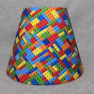 Covered with Building blocks lamp shade.  Fabric.  Blue green yellow red orange.  Lego look.   Shades are 9.5&quot; x 5&quot; x 7&quot; tall