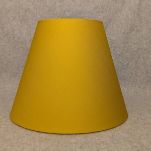 Golden lamp shade.  Solid color. Gold.  Mustard. Shade is 9.5 wide at the bottom, 5" wide at the top and 7" tall