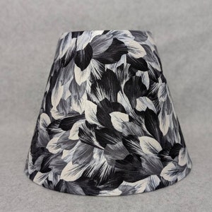 Black and white petal lamp shade.  Shiny white petals. Flowers.  Shade is 9.5 wide at the bottom, 5&quot; wide at the top and 7&quot; tall