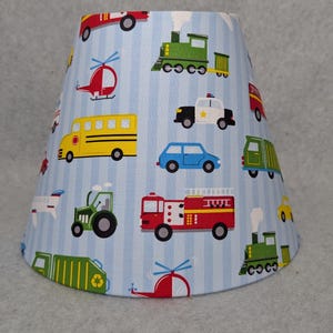 Transportation vehicles lamp shade.  Tractor, train, airplane, police car, firetruck, ambulance.  Shades are 9.5&quot; x 5&quot; x 7&quot; tall