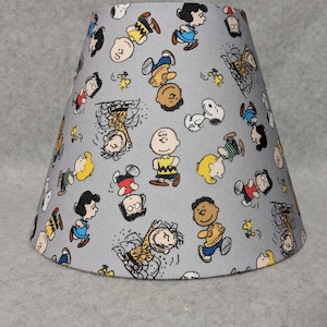 Peanuts lamp shade.  Snoopy.  Charlie brown.  Shade is 9.5" wide at the bottom, 5" wide at the top and 7" tall
