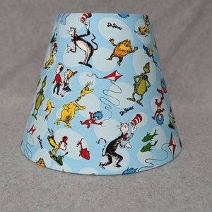 Dr. Seuss shade. Light blue.  Characters are random.  Cat in the hat, Horton, who, thorax, thing.  Shades are 9.5" x 5" x 7" tall