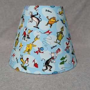 Dr. Seuss shade. Light blue.  Characters are random.  Cat in the hat, Horton, who, thorax, thing.  Shades are 9.5&quot; x 5&quot; x 7&quot; tall