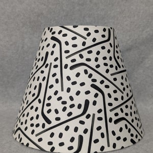 Hockey lamp shade.  Pucks and sticks.  Black and off-white.  Shades are 9.5&quot; x 5&quot; x 7&quot; tall