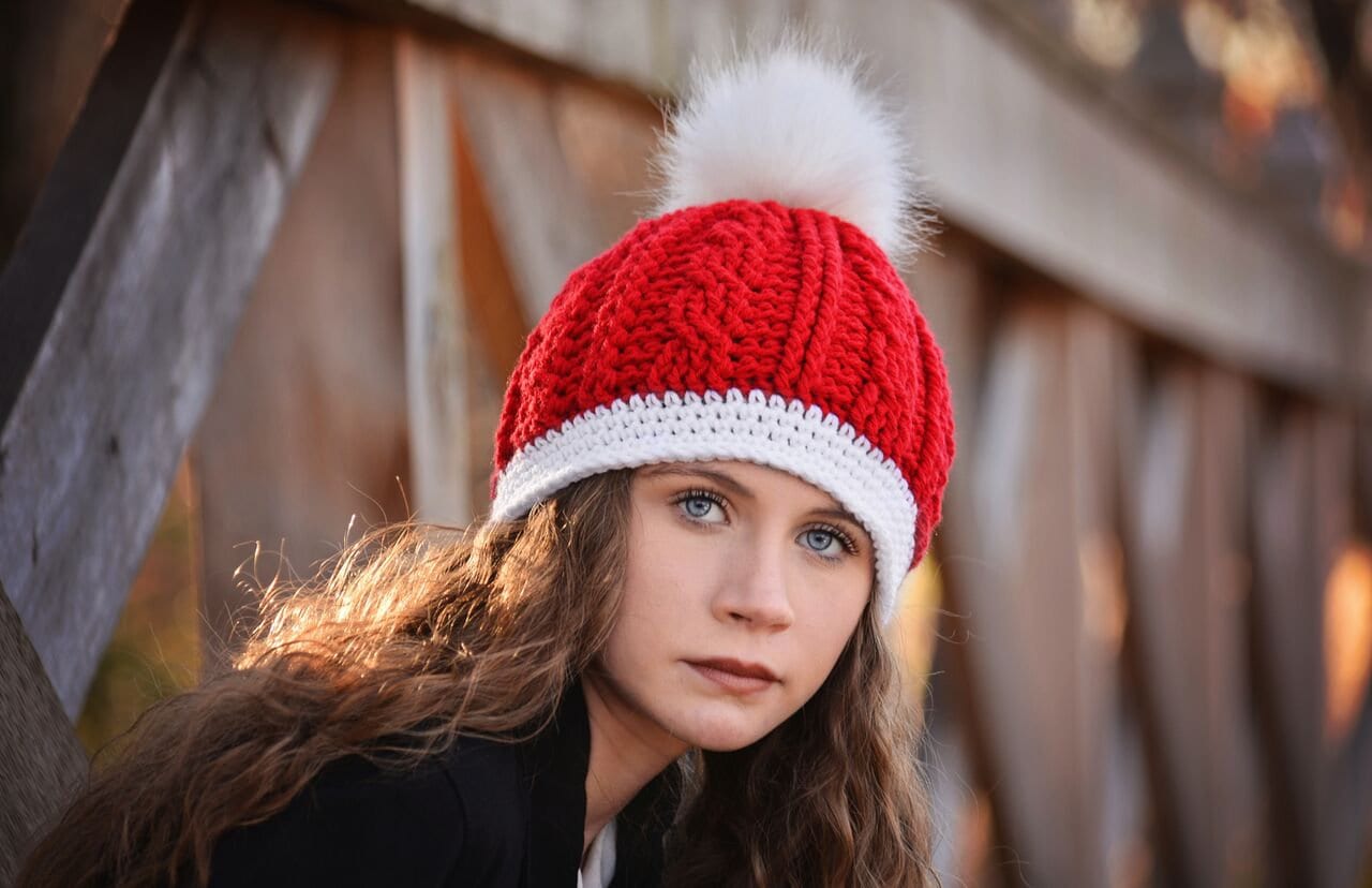 Meadow Cable Knit Beanie with Finn Raccoon Fur Pom Pom in Red
