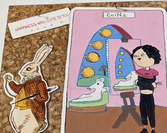 May include: A handmade collage on corkboard featuring a white rabbit in a suit and a tarot card illustration. The tarot card has a pink background with the word "Coin&" at the top and "Eight" at the bottom. The text "Happiness Will Come To You" is also present.