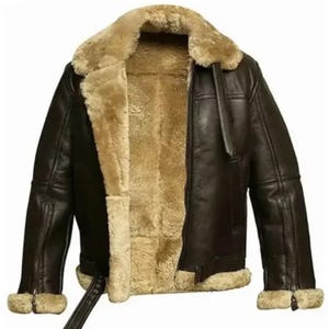 May include: A brown leather jacket with a beige shearling lining and collar. The jacket features a zip closure, a belt at the waist, and shearling trim on the cuffs. This warm jacket is designed for cold weather.
