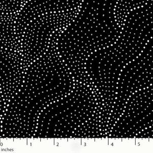May include: Black fabric with a pattern of white and light gray dots. The dots vary in size and density, creating a speckled effect. The fabric is measured in inches.