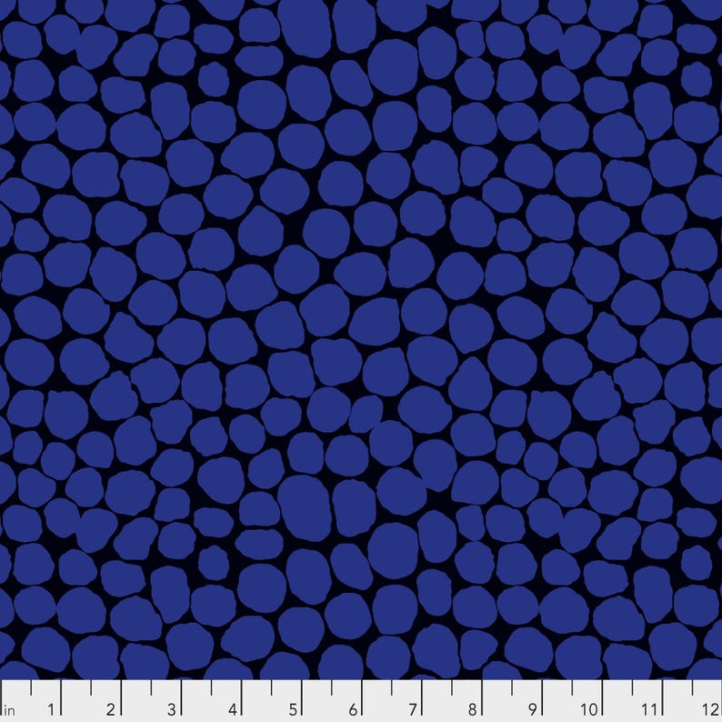 The image is a close-up of a pattern of blue circles or dots on a dark background.
