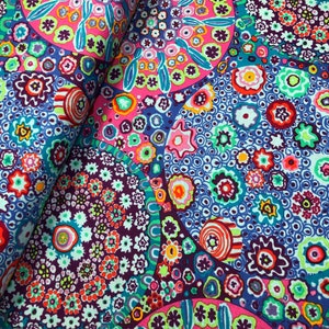 May include: Colorful fabric with a repeating pattern of circles and swirls in shades of pink, blue, green, and purple.