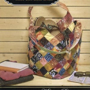 May include: Quiltsmart Mondo Bag sewing pattern featuring a colorful patchwork tote bag with a zipper closure. The pattern includes instructions for a large bag with a simple technique and fusible interfacing.  EASY! FAST! SMART!