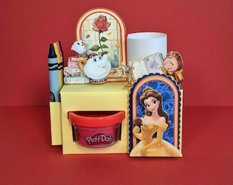 May include: A yellow desk organizer featuring Beauty and the Beast characters, including Belle, Chip, and Cogsworth. The unit includes a cylindrical pen holder, a slot for a Play-Doh container, and a decorative back panel with a rose illustration.