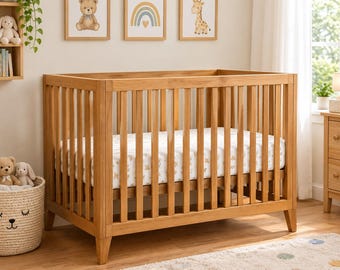 May include: A light brown wooden crib with vertical slats and a white mattress featuring a subtle tan pattern. The crib has a rectangular frame with four sturdy legs and is positioned in a room with light-colored walls and wooden flooring.