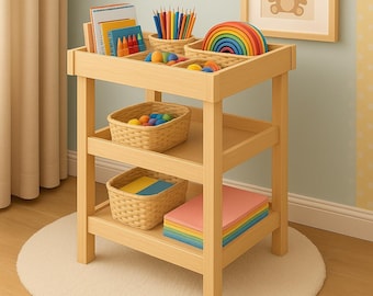 May include: A light wood children's activity table with multiple compartments and shelves. The top section holds art supplies, including crayons, colored pencils, and a wooden rainbow. Two woven baskets and a stack of colorful paper are on the lower shelves.