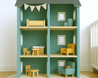 May include: A multi-story dollhouse with a green exterior and a gray roof. The interior features miniature furniture, including a bed, chairs, and a sofa, all in shades of yellow and teal. A white banner hangs from the roof.
