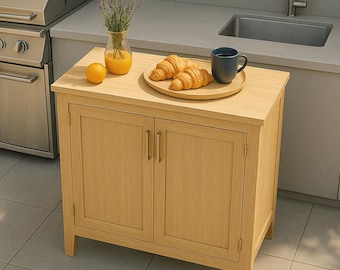 May include: A light oak cabinet with two doors, a countertop, and a small wooden tray with two croissants and a blue mug. A vase with lavender and a glass of orange juice sit on the countertop, along with an orange. The cabinet is in an outdoor kitchen setting.