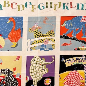 May include: A colorful alphabet fabric panel with illustrations of animals. The panel features a duck, a cow, an elephant, and a pig. The text "Mud Baths Thick-Oozy Club" is also included.