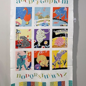 May include: White fabric with a colorful alphabet design. Each letter is paired with an illustration of an animal. The letters are in a green font and the animals are in a variety of colors. The fabric has a patchwork border with red, blue, yellow, and green squares.