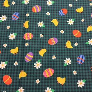 May include: Green fabric with a checkered pattern featuring yellow chicks, white daisies, and colorful Easter eggs.