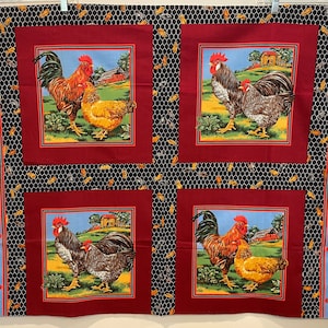 May include: Red fabric with a black and white honeycomb pattern. Four red squares with white borders feature a rooster and hen in a barnyard setting. The rooster is red and the hen is gray. The background is blue with a red barn.