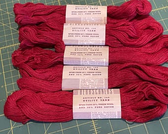 May include: Five spools of red utility yarn, each with a label that reads "Article No. 120 Utility Yarn, spun from 50% virgin wool and 50% pure rayon".