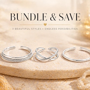 May include: Three silver-colored adjustable rings are displayed on a beige stone surface. The rings have different designs: one with a textured band, one with an X-shaped design, and one with a simple band. The text "BUNDLE & SAVE" is at the top.