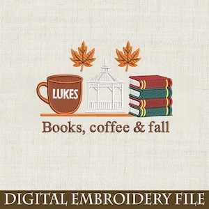 May include: An embroidered design with a brown coffee mug labelled "Lukes", a white gazebo, and a stack of books. Two orange autumn leaves are above the gazebo. The text "Books, coffee & fall" is below. The words "DIGITAL EMBROIDERY FILE" are at the bottom.