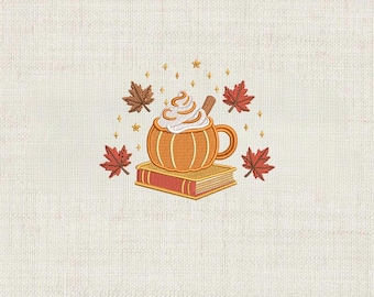 May include: An embroidered design featuring a pumpkin-shaped mug filled with whipped cream and a cinnamon stick, resting on a book. Surrounding the mug are autumn leaves and stars. The text "DIGITAL EMBROIDERY FILE" is at the bottom.