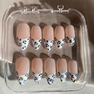 Unhas postiças artesanais com ponta francesa em tons de mirtilo, estilo primavera, formato amendoado.