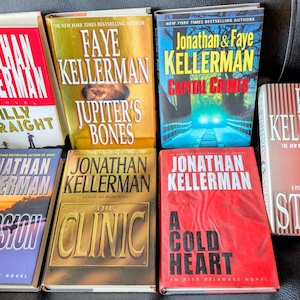 May include: A selection of hardcover books by Jonathan and Faye Kellerman. Titles include "Billy Straight", "Jupiter's Bones", "Capital Crimes", "Obsession", "The Clinic", "A Cold Heart", and "Stalker". The books have striking covers with author names and titles.