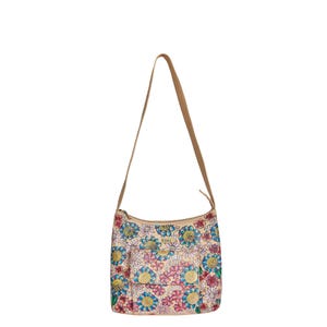 May include: A beige floral shoulder bag with a tan strap. The bag features a colorful pattern of blue, pink, and yellow flowers. It has a front pocket and a zipper closure. The bag is designed for everyday use.