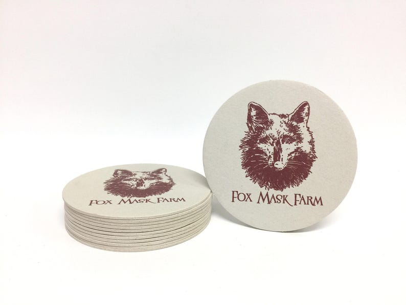 Custom design coasters featuring red Fox Mask Farm logo design. Coasters are shown against a white background.