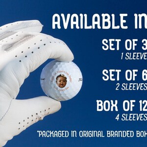 Image: Hand holding golf ball with 1st Fathers Day photo design in orange color option Text: Available in Set of 3 (1 Sleeve), Set of 6 (2 Sleeves), Box of 12 (4 Sleeves) *Packaged in original branded box