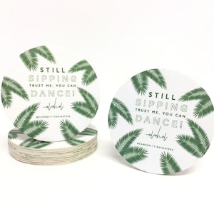 Custom design coasters featuring Still Sipping palm frond design. Coasters are shown against a white background.